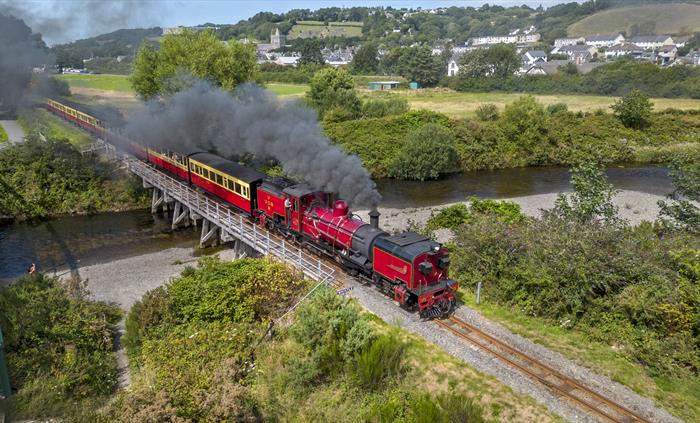 The Garratt locomotive steaming over a timber trestle bridge in Llanbadarn as it departs Aberystwyth.